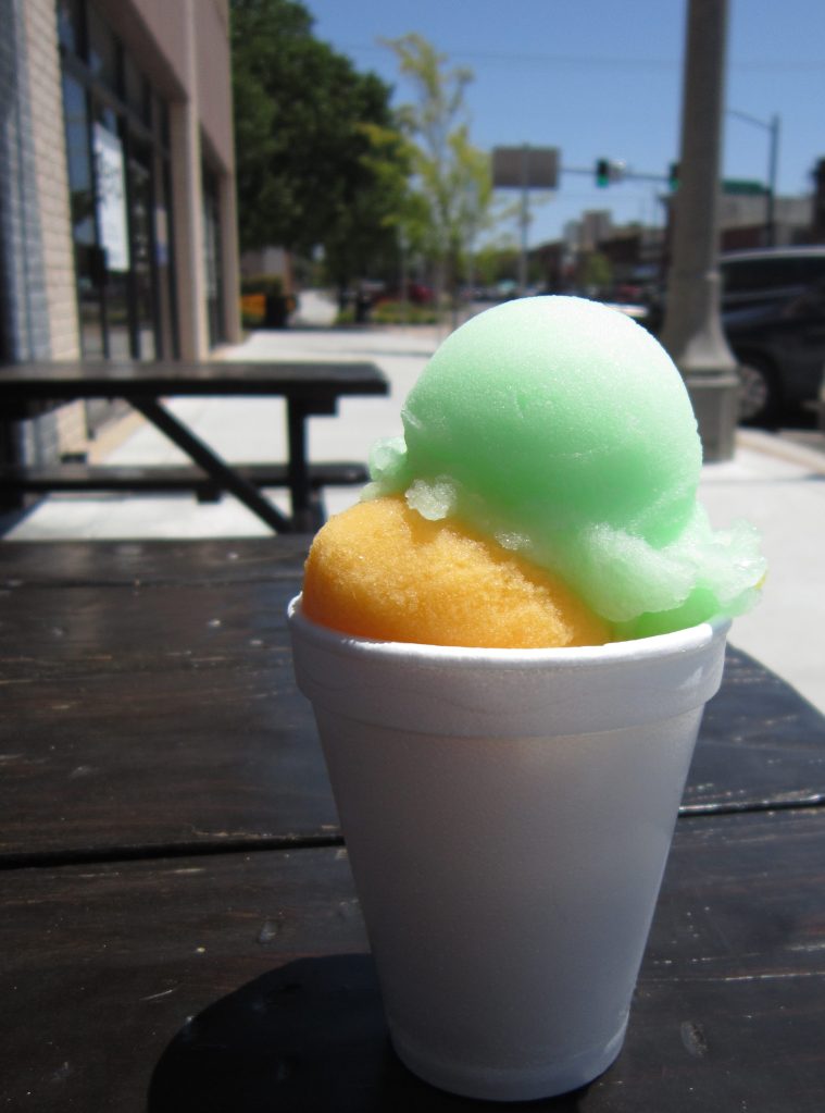 brightly colored green and orange Italian ice in a cup at Tino's in Norman
